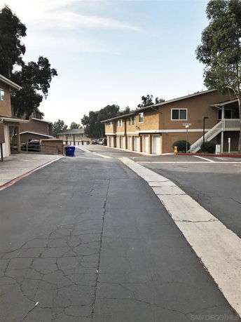 Outdoor parking area with multiple garages in an apartment complex.