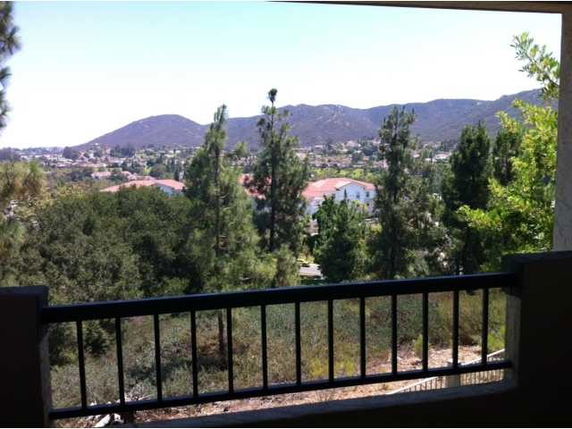 Panoramic view of a landscape with hills and trees seen from a building.