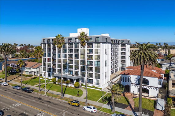 Front view of a multi-story apartment building with several balconies.