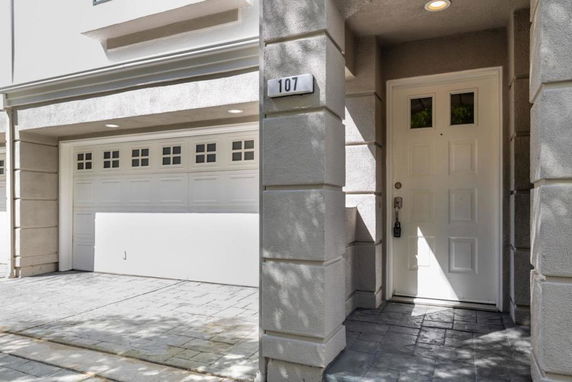 Front view of a house with a white door and garage.