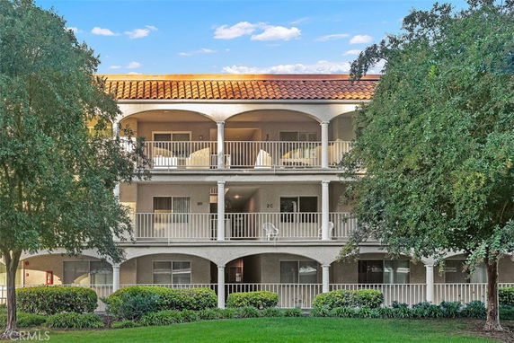 Front view of a three-story building with balconies.