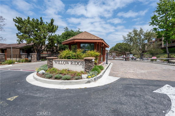 Front view of a building entrance at Willow Ridge with a small guardhouse.
