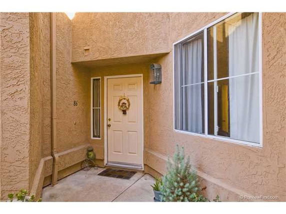 Front view of a house entrance with a wreath on the door.