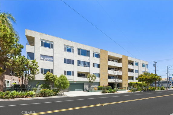 Front view of a multi-story residential building with a modern design.