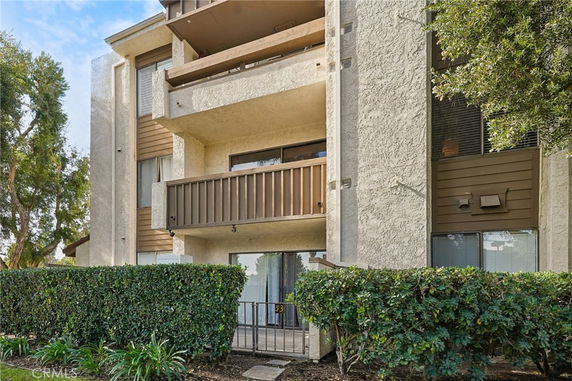 Front view of a multi-story apartment building with balconies.