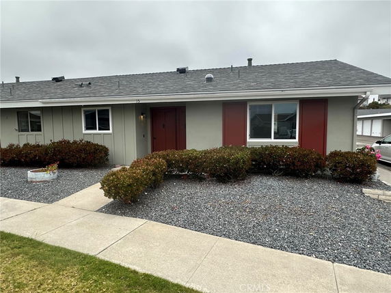 Front view of a single-story house with red shutters.