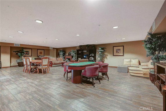 Indoor recreational area with card tables, seating, and decorations.