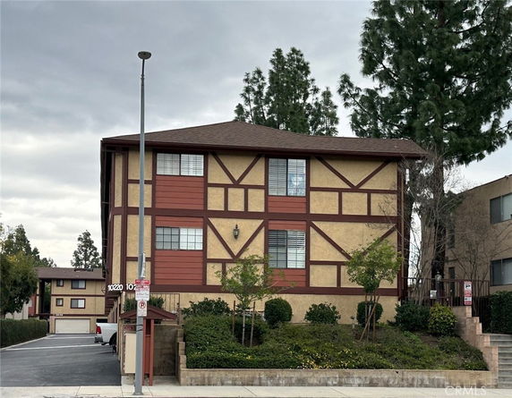 Front view of a multi-story building with a Tudor-style design.