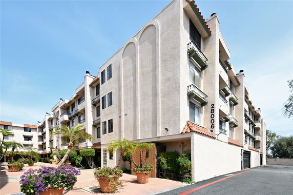 Front view of a large multi-story residential building with balconies.