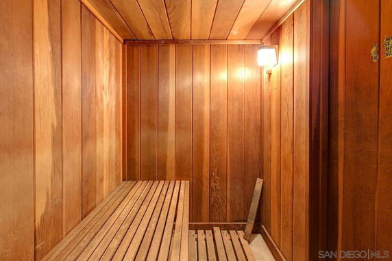 Interior view of a wooden sauna room with bench seating.