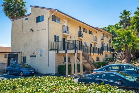 Front view of a multifamily apartment building with staircases and balconies.