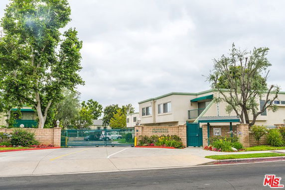 Front view of a residential building with gated entrance
