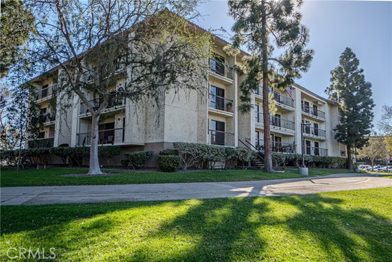 Front view of a multi-story residential building with balconies.