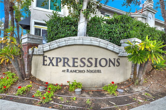 Front view of a multistory residential building with a sign reading 'Expressions at Rancho Niguel'.