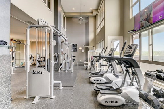 Interior view of a gym with exercise machines and equipment.