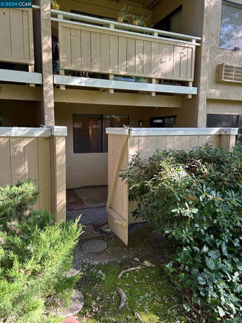 Front view of a building with a small porch and balcony.
