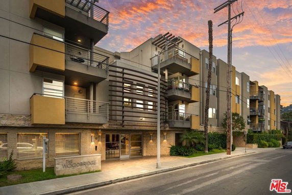 Front view of a multi-story apartment building with balconies.