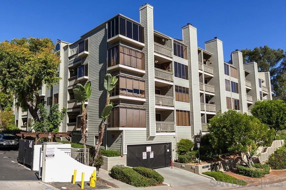 Front view of a multi-story residential building with balconies.