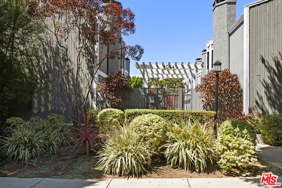 Front view of residential buildings with a pergola entrance.