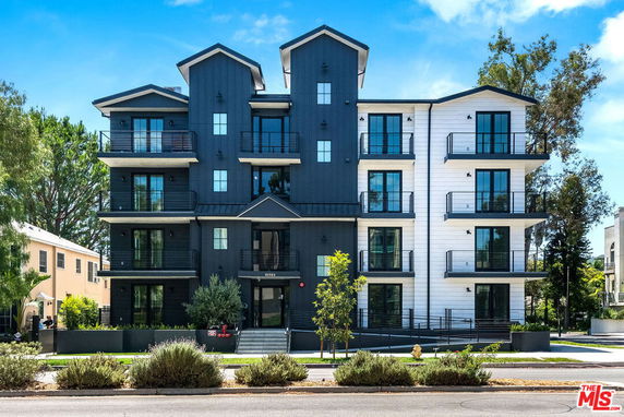 Front view of a multi-story residential building with balconies.