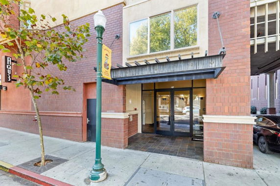 Front view of a brick commercial building entrance with glass doors.
