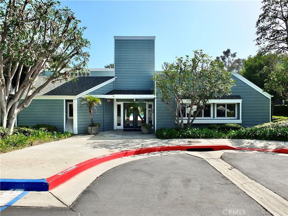 Front view of a single-story house with blue siding and a central entrance.