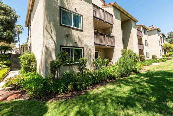 Front view of a multi-story apartment building with balconies.