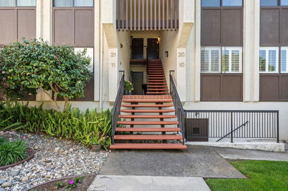 Front view of a building with an exterior staircase leading to the entrance.