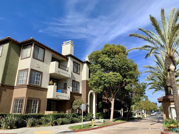 Front view of a multi-story residential building with balconies.