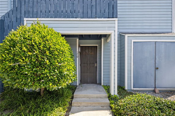 Front view of a house with a blue exterior and covered entrance.
