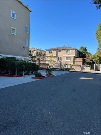 Front view of multi-story residential buildings with gated entry.
