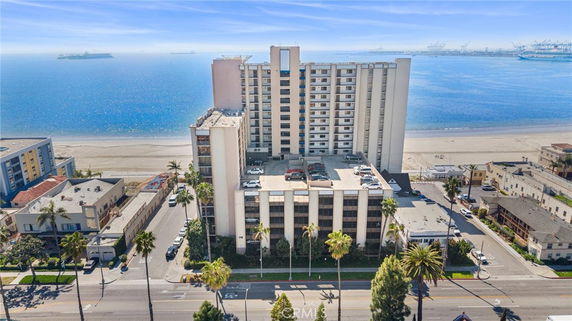 Front view of a tall beachfront apartment building with multiple floors.