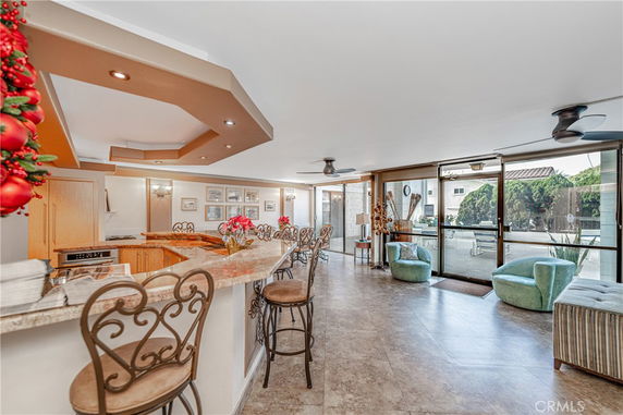 Interior view of a clubhouse with bar seating and large windows.