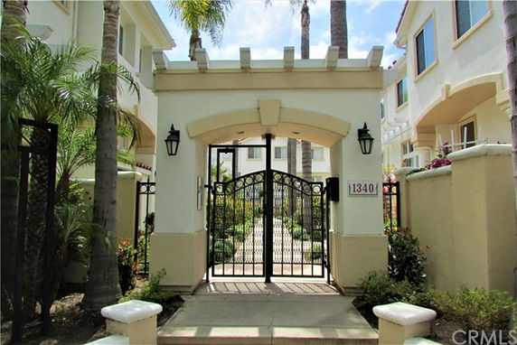 Front entrance of a multi-story residential building with gated entry.