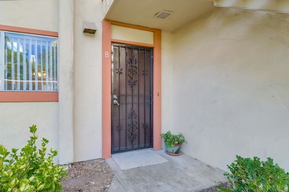 Front view of an entrance to an apartment unit with a metal door and adjacent window.