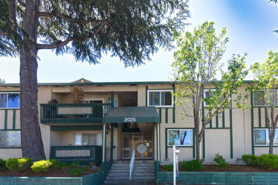 Front view of a two-story apartment building with balconies.