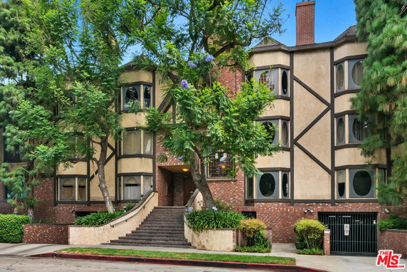 Front view of a multi-story building with Tudor-style architecture.