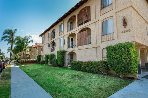 Front view of a multi-story residential building with balconies.