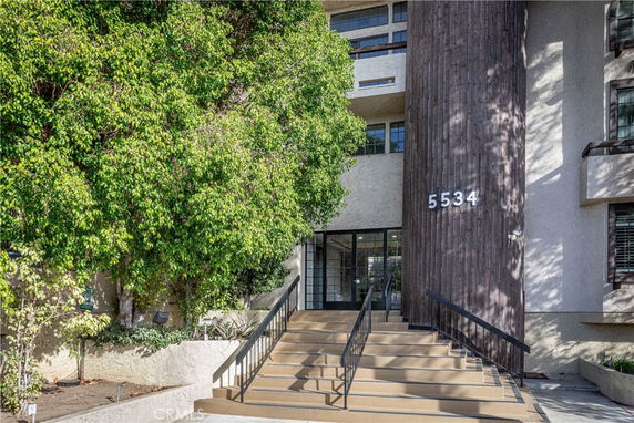 Front view of a multi-story building with prominent entrance stairs.