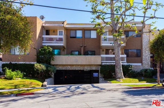 Front view of a two-story apartment building with balconies.
