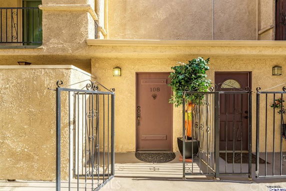 Entrance view of a building with two doors and potted plants.