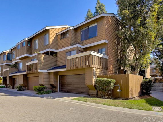 Front view of a multi-story townhouse complex with garages.