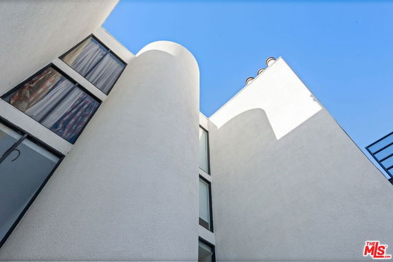 Exterior view of a modern building with curved and angular design elements.