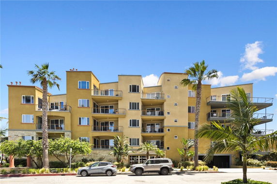 Front view of a multi-story residential building with balconies.