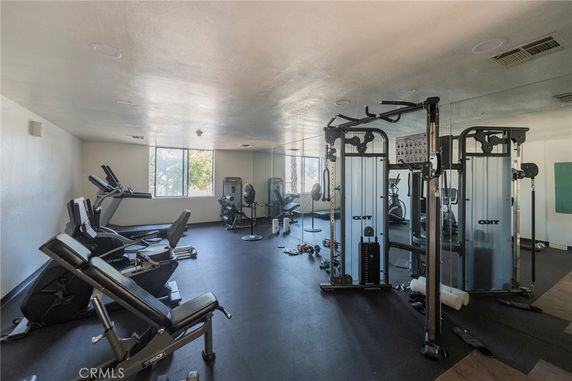 Indoor gym area with exercise equipment and mirrors