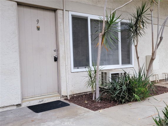 Front view of a building entrance with a door and a window.