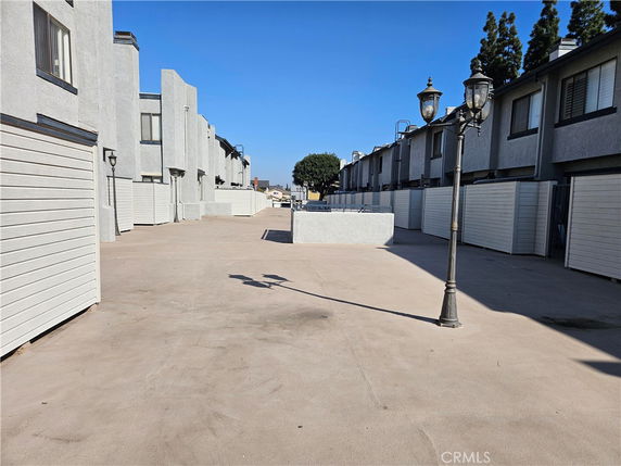 Outdoor view of two-story residential buildings with white exteriors.