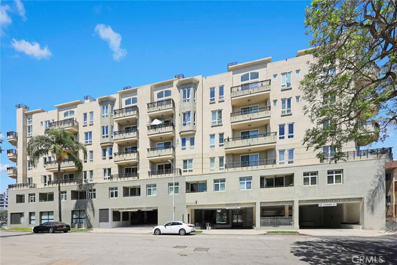 Front view of a multi-story residential building with balconies.