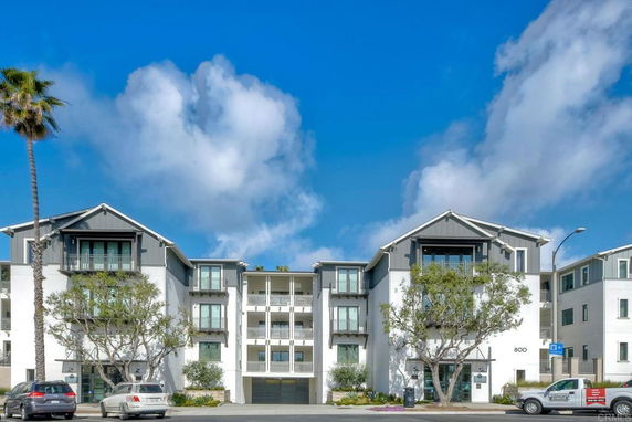 Front view of a multi-story apartment building with a modern design.
