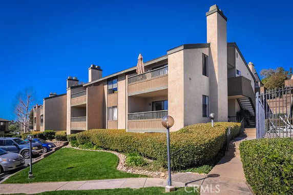 Front view of a two-story apartment building with balconies.